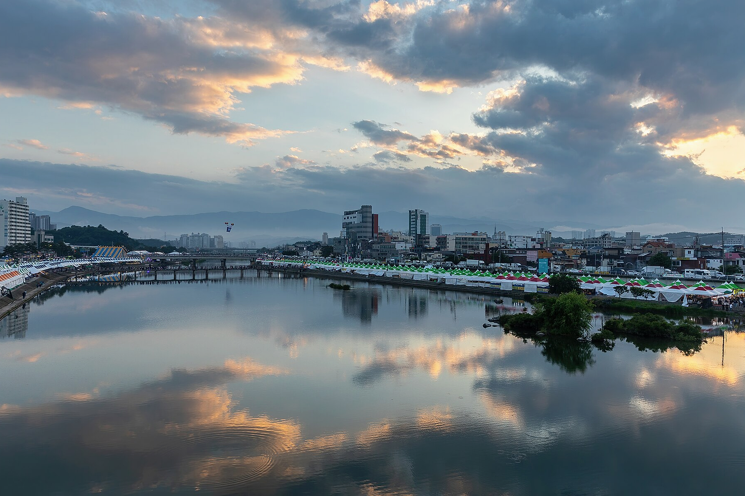 Namdae stream water reflection of colorful clouds from Wolhwagyo bridge (강릉월화교), during the celebration of Gangneung Danoje in Gangneung , South Korea .