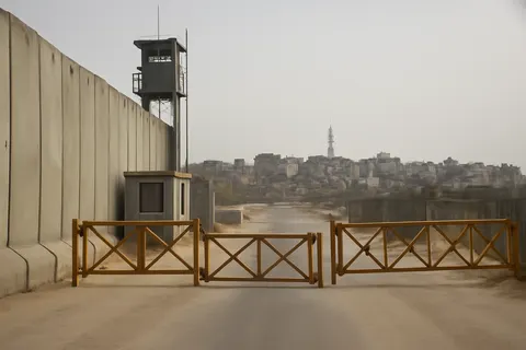 Grounded editorial scene illustrating Since a U.S.-brokered ceasefire last year, Israeli forces have advanced beyond their previous control of half of Gaza, leading to heightened violence and deadly consequences for Palestinians.