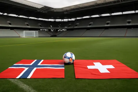 Grounded editorial scene illustrating England faces Norway and defending champions Argentina take on Switzerland for the last two semifinal spots in the 2026 FIFA World Cup.
