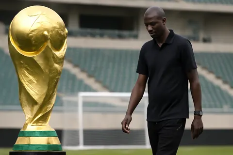 Grounded editorial scene illustrating After a disappointing performance at the 2026 FIFA World Cup, Senegal has parted ways with head coach Pape Thiaw, with Patrick Vieira reported as a leading candidate to replace him.
