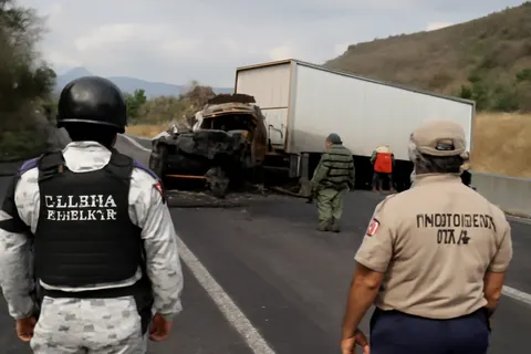 Grounded editorial scene illustrating A tractor-trailer brake failure caused a chain-reaction pileup on a highway in western Mexico, resulting in multiple fatalities and injuries including four U.S. citizens.