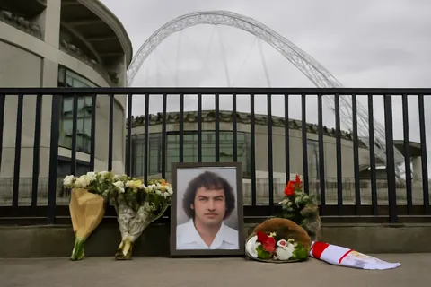 Grounded editorial scene illustrating Kevin Keegan, celebrated footballer and manager, passed away at 75, prompting heartfelt reactions and plans for a full tribute at Wembley.