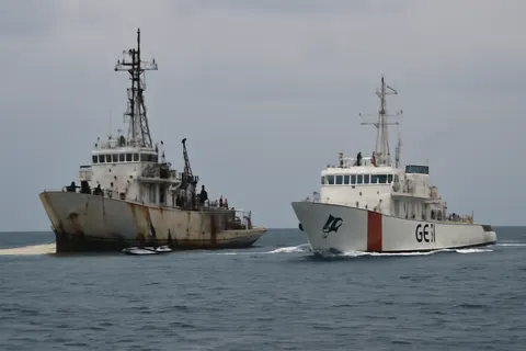 Grounded editorial scene illustrating Beijing summoned the Philippine ambassador following a confrontation between their vessels near the Second Thomas Shoal in contested South China Sea waters.