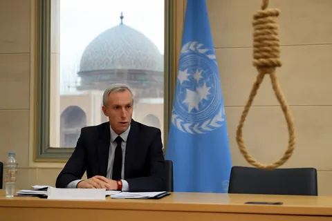 Grounded editorial scene illustrating Independent UN investigators call on Iran to stop the execution of 10 men arrested after January protests in Isfahan, amid concerns over a rising number of death sentences related to nationwide unrest.