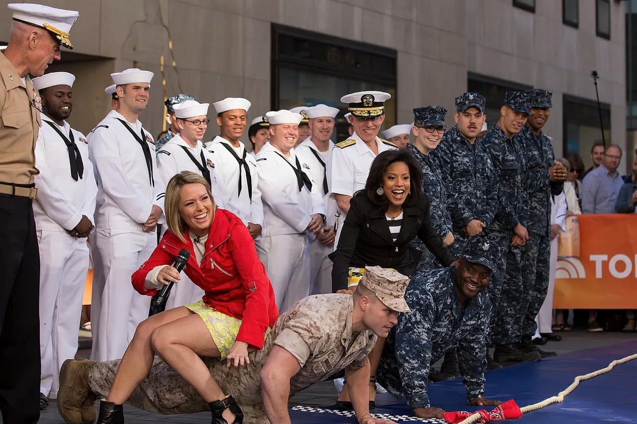 150523-M-TV331-061 Cpl. Stephen Hardcastle, a Marine with Special-Purpose Marine Air Ground Task Force-New York from Santa Fe, Texas, shows his strength prior to the tug-of-war event on the "Today" show as a part of Fleet Week New York, New York City, May 23, 2015. Marines with SP-MAGTF-NY showcase the capabilities of the Marine Corps both physically, mentally and technologically during Fleet Week New York. Fleet Week is an annual event that provides New York and surrounding area a chance to see the sea services capabilities. (U.S. Marine Corps photo by Cpl. Justin T. Updegraff/ Released) Note: Today show meteorologist Dylan Dreyer is wearing the ref jacket and Sheinelle Jones is wearing the black one.