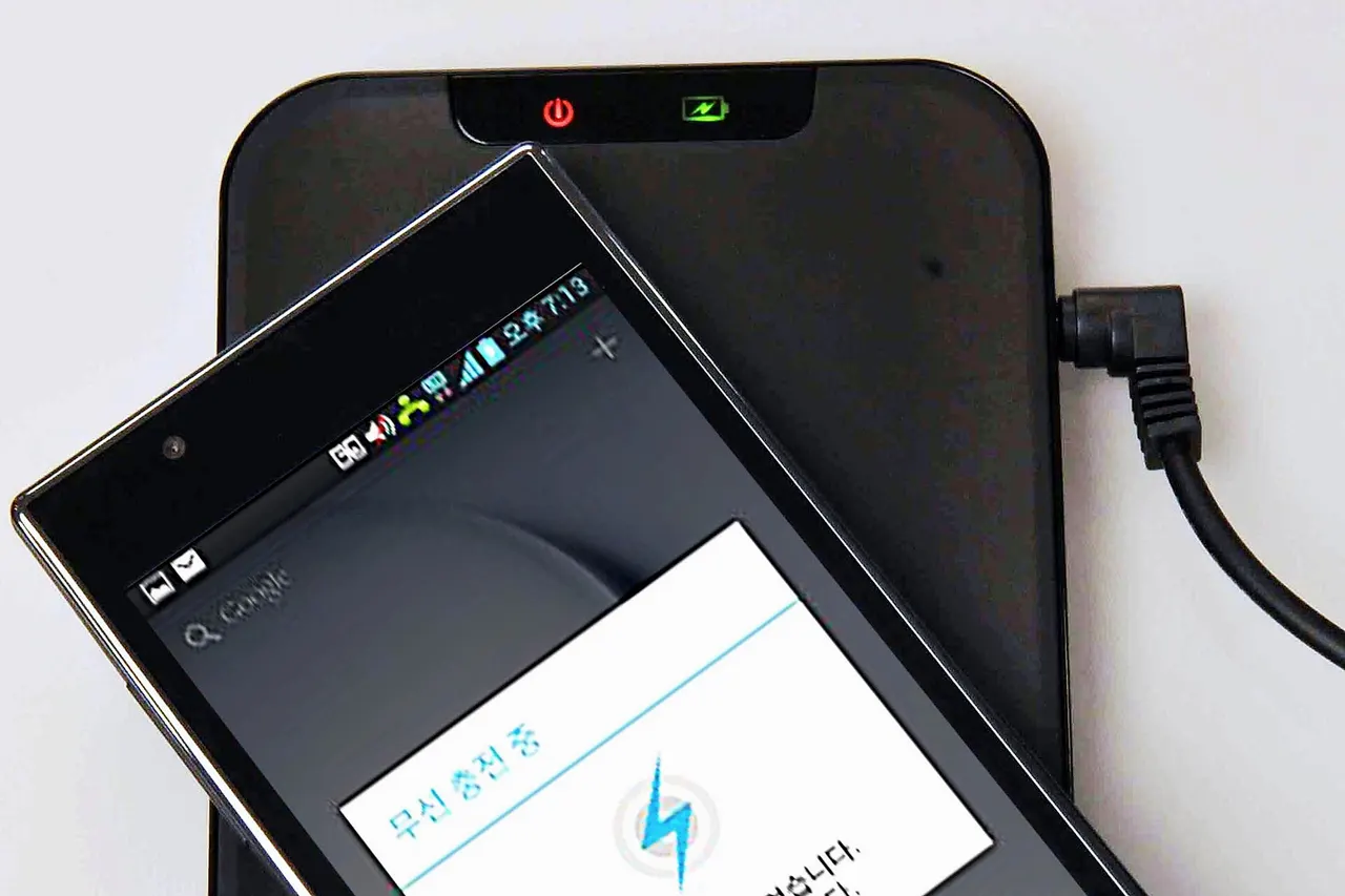 Wireless charging pat for LG smartphone, using the Qi (pronounced 'Chi') international inductive power standard published by the Wireless Power Consortium (WPC). The phone is placed on the pad and it automatically charges.