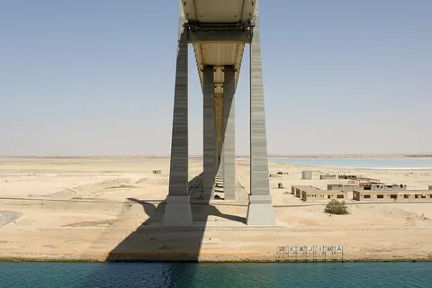 The Suez Canal Bridge crosses the Canal at El Qantara . It is also known as the Shohada 25 January Bridge or the Egyptian-Japanese Friendship Bridge .