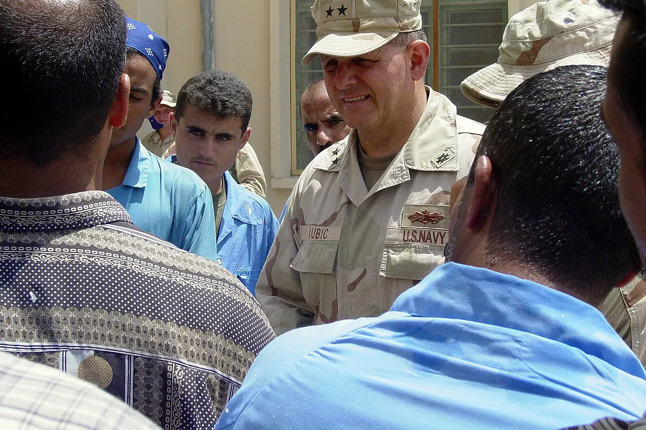 Umm Qasr, Kuwait (Apr. 24, 2003) -- Rear Adm. Charles Kubik, Commander, First Naval Construction Division, speaks to the citizens of Umm Qasr about the newly renovated Umm Qasr High School. The Seabees rebuilt the high school while in support of Operation Iraqi Freedom. Operation Iraqi Freedom is the multi-national coalition effort to liberate the Iraqi people, eliminate Iraq's weapons of mass destruction and end the regime of Saddam Hussein. U.S. Marine Corps photo by Maj. Kathleen A. Hoard. (RELEASED)
