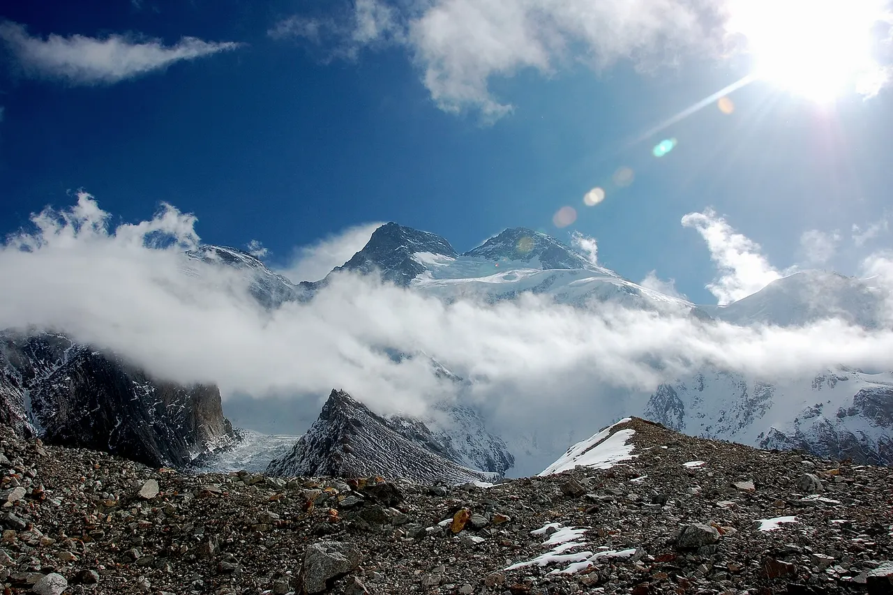 Broad Peak from Godwin-Austen Glacier: Broad Peak North on the links (Behind clouds), Broad Peak Central (centre left) and Broad Peak Main (centre right)