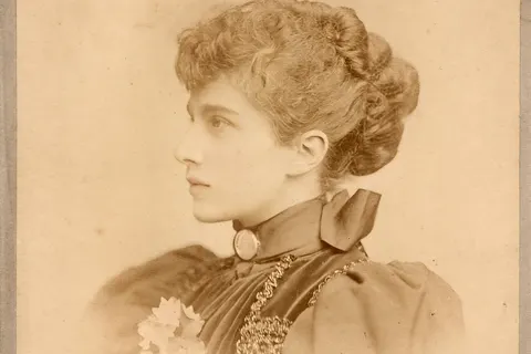 This photograph from the Victorian-era, presented in cabinet format, portrays an elegant young lady captured by the skill of photographer Arthur Langton. Taken around 1893 at 35 Buckingham Palace Road, in the Belgravia district of London, England. This digitized photograph at high resolution of 1600 DPI, has been enhanced and transformed by AI, accentuating facial contrast and beauty.