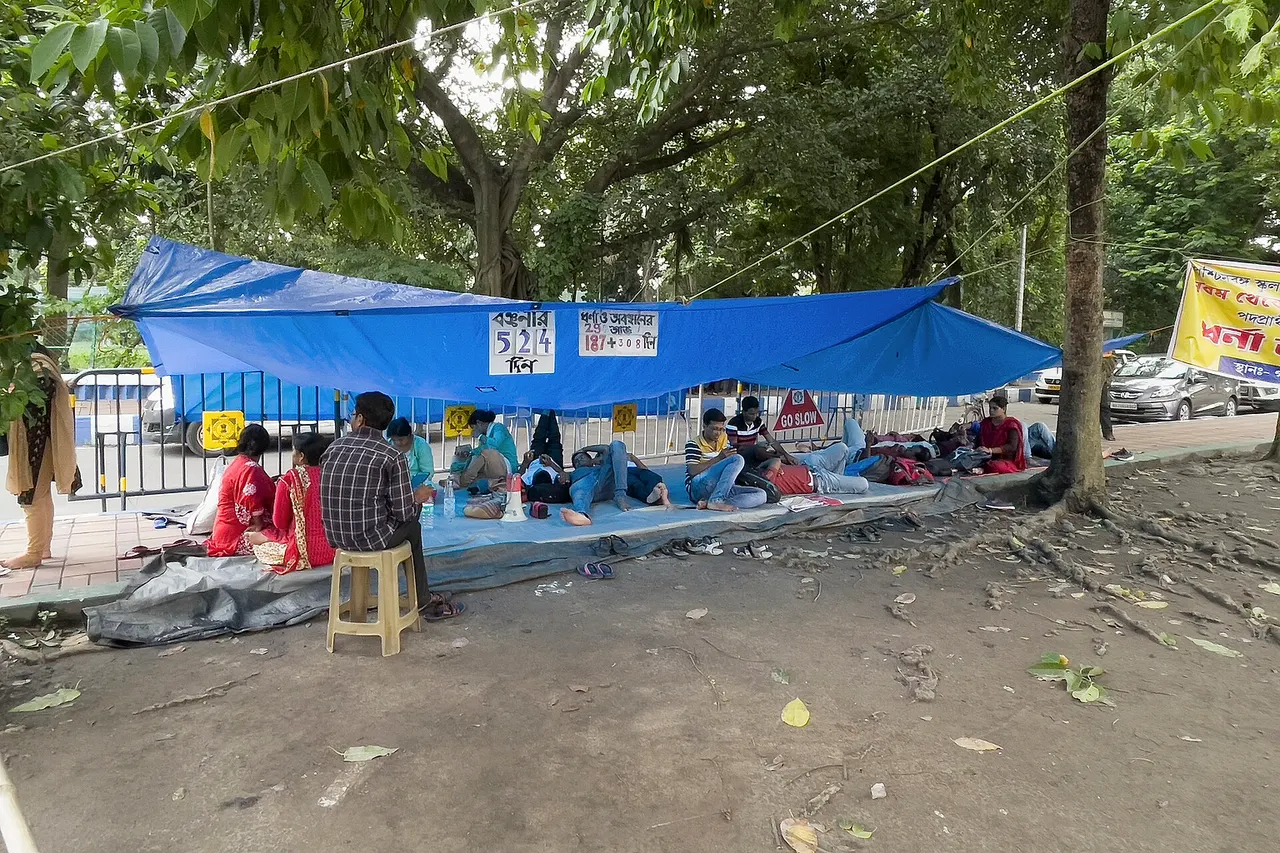 TET passed candidates who are protesting over SSC scam in West Bengal. Protesters are sitting peacefully beneath the statue of Mahatma Gandhi in Kolkata Maidan. This photograph has been taken on the 524th Day of onging protest over the education scam.