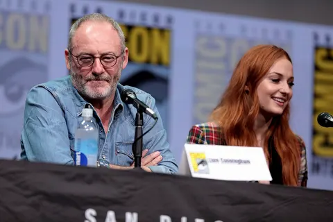 Liam Cunningham and Sophie Turner speaking at the 2017 San Diego Comic Con International, for "Game of Thrones", at the San Diego Convention Center in San Diego, California. Please attribute to Gage Skidmore if used elsewhere.