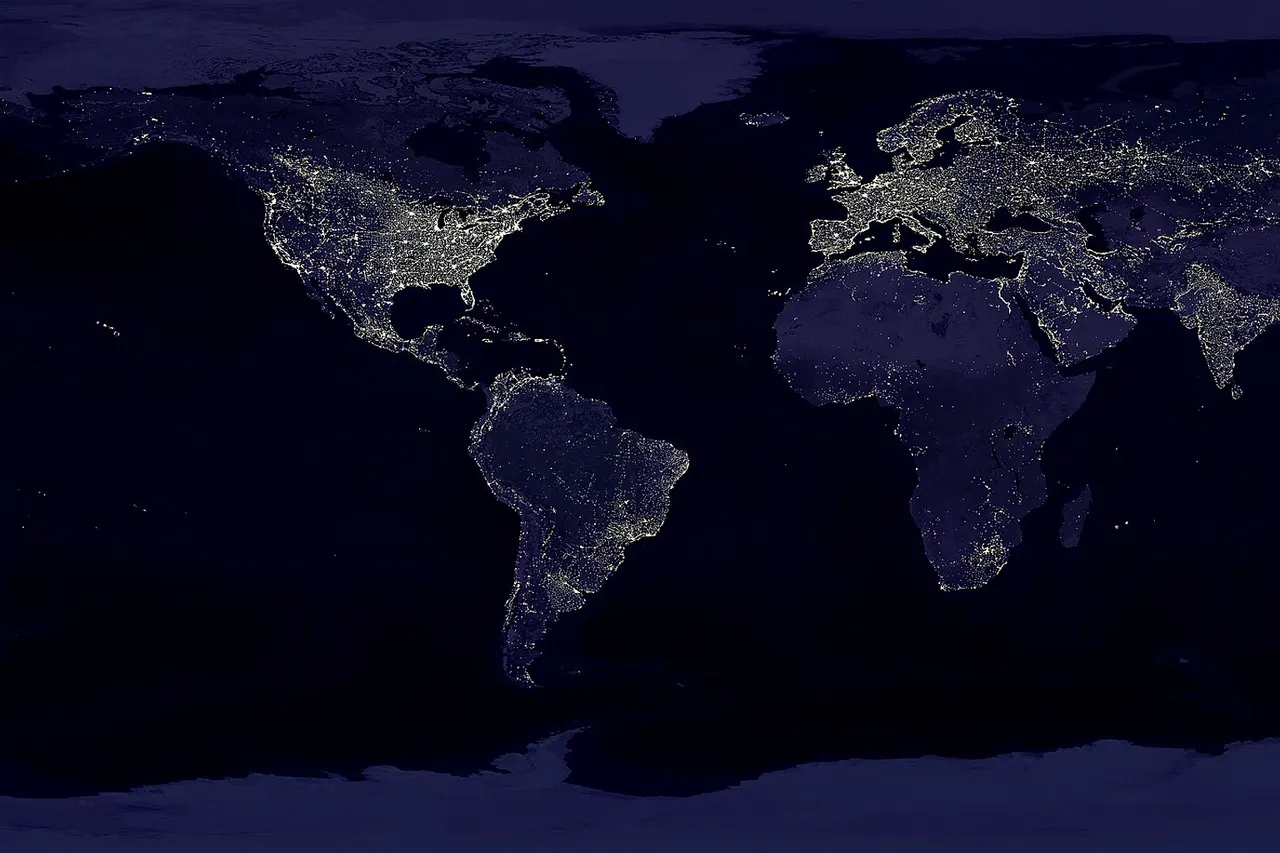 This image of Earth’s city lights was created with data from the Defense Meteorological Satellite Program (DMSP) Operational Linescan System (OLS). Originally designed to view clouds by moonlight, the OLS is also used to map the locations of permanent lights on the Earth’s surface. The brightest areas of the Earth are the most urbanized, but not necessarily the most populated. (Compare western Europe with China and India.) Cities tend to grow along coastlines and transportation networks. Even without the underlying map, the outlines of many continents would still be visible. The United States interstate highway system appears as a lattice connecting the brighter dots of city centers. In Russia, the Trans-Siberian railroad is a thin line stretching from Moscow through the center of Asia to Vladivostok. The Nile River, from the Aswan Dam to the Mediterranean Sea, is another bright thread through an otherwise dark region. Even more than 100 years after the invention of the electric light, some regions remain thinly populated and unlit. Antarctica is entirely dark. The interior jungles of Africa and South America are mostly dark, but lights are beginning to appear there. Deserts in Africa, Arabia, Australia, Mongolia, and the United States are poorly lit as well (except along the coast), along with the boreal forests of Canada and Russia, and the great mountains of the Himalaya.