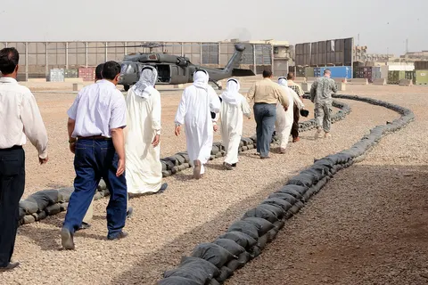 Participants in a meeting between the Sunni organization Sahwa, and Iraqi national police leaders, prepare to board a UH-60 Blackhawk helicopter, at Joint Security Station Loyalty, eastern Baghdad, Iraq, on May 16. The meeting was held to discuss the future of the Sons of Iraq and other issues of concern.