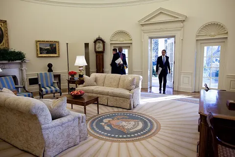 Barack Obama first enters in the Oval Office as president of the United States, for his first full day in office, Jan. 21, 2009. His Personal Aide Reggie Love stands nearby.
