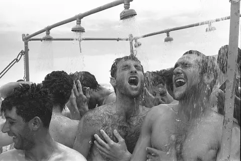 Soldiers enjoy a sweet field shower near Eilat . Five days before the start of the Six-Day War .