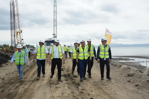 The Department of Public Works and Highways (DPWH) continues to make significant strides in the implementation of its Davao River Bridge Project also known as the Bucana Bridge which is an Integral [art of the Davao City Coastal Bypass Road. In his Inspection Teport to DPWH Secretary Manuel M. Bonoan, Senior Undersecretary Emil K. Sadain said that the Unified Project Management Office - Bridges Management Cluster (UPMO-BMC) is working closely in the implementation of the 1.34-kilometer Bucana Bridge Project with its contractor China Road and Bridge Corporation (CRBC) pushing forward with its Vonstruction Sctivities beginning last November 2023 and currently focused on the Bored Piling Works. According to Senior Undersecretary Sadain, In-Charge of DPWH Infrastructure Flagship Projects, construction of this modern Bridge will be finished in 24 months and is expected to be open to traffic in the first Quarter of 2026 which can approximately hold about 35,000 Vehicles every Day, alleviating the East-West Traffic Congestion in the Coastal Areas of Davao City. Senior Undersecretary Sadain together with UPMO-BMC Project Director Rodrigo I. Delos Reyes inspected on Friday, April 5, 2024 the On-Going Construction of a four (4) Lane six (6) Span Extradosed Bridge and Approach Roads located at the Estuary of the Davao River. Also joining in the Inspection are UPMO - Roads Management Cluster 1 (Bilateral) Project Director Benjamin A. Bautista, Stakeholders Relations Service Director Randy R. Del Rosario, and UPMO Project Manager Joweto V. Tulaylay. The Bucana Bridge will be one of the pioneering Infrastructure Landmarks for the Build Better More agenda of President Ferdinand R. Marcos Jr. Administration under the Bagong Pilipinas Brand of Governance and Leadership. The total length of the Bridge is 480 meters with Embankment Roads of 420 meters and 440 meters and width of the Bridge Deck is 22.24 meters, designed for a bidirectional four (4)-lane Setup. The main Bridge Foundation consists of 1.5-meter diameter Bored Piles, with Pier Caps and Portal Piers while the Height of the Bridge Towers is 19.5 meters, with a total of five (5) Towers. The Main Beams are a double-hole cast-in-place hollow beam Structure, with a 10-centimeter thick Asphalt Concrete Pavement on the Bridge Deck and Steel Structure Guardrails on both Sides. From the onset of its mobilization during the last Quarter of 2023, the Project has been underway for several Months with DPWH Government Engineers headed by Project Manager Norifel Teddie G. Cadiang and Project Engineer John Christian T. Gaden and the Contractor’s Construction Crews working tirelessly in attaining the present Accomplishment Status at 8.23%. With a total Project cost of P4.304 Billion, the Project is funded by the assistance of the Government of the People’s Republic of China (GPRC) under the China Aid-Grant. The ongoing construction Project is providing local employment opportunities with about 83% of the Workers involved in the Project being Filipinos. The Detailed Engineering Design for the Project was completed on April 28, 2023 by the Consortium of CCCC Highway Consultant Co., Ltd. and Beijing Zhongjiao Road and Bridge Supervision Co., Ltd who are likewise providing Consulting Services on the construction supervision of the Bucana Bridge. Although challenges affecting the Project implementation are inevitable, DPWH has always guaranteed to provide the utmost transparency and accountability in delivering top-notch Infrastructure Facilities all centered on improving the Lives of every Filipino. Furthermore, the Bucana Bridge is anticipated to complement the Davao City Coastal Road serving as an alternative Route to the existing Urban Road Network in Davao that will aid in decongesting the traffic in the old Route. Once finished, the Project will become an added Gateway towards faster movement of Economic Activities, more livelihood Opportunities, and the promotion of Tourism across Davao City.