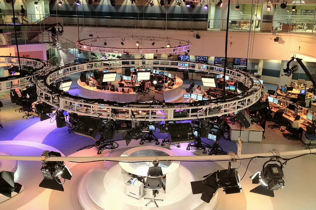 Photo from balcony overlooking main television studio from behind presenter's desk in the Doha headquarters.