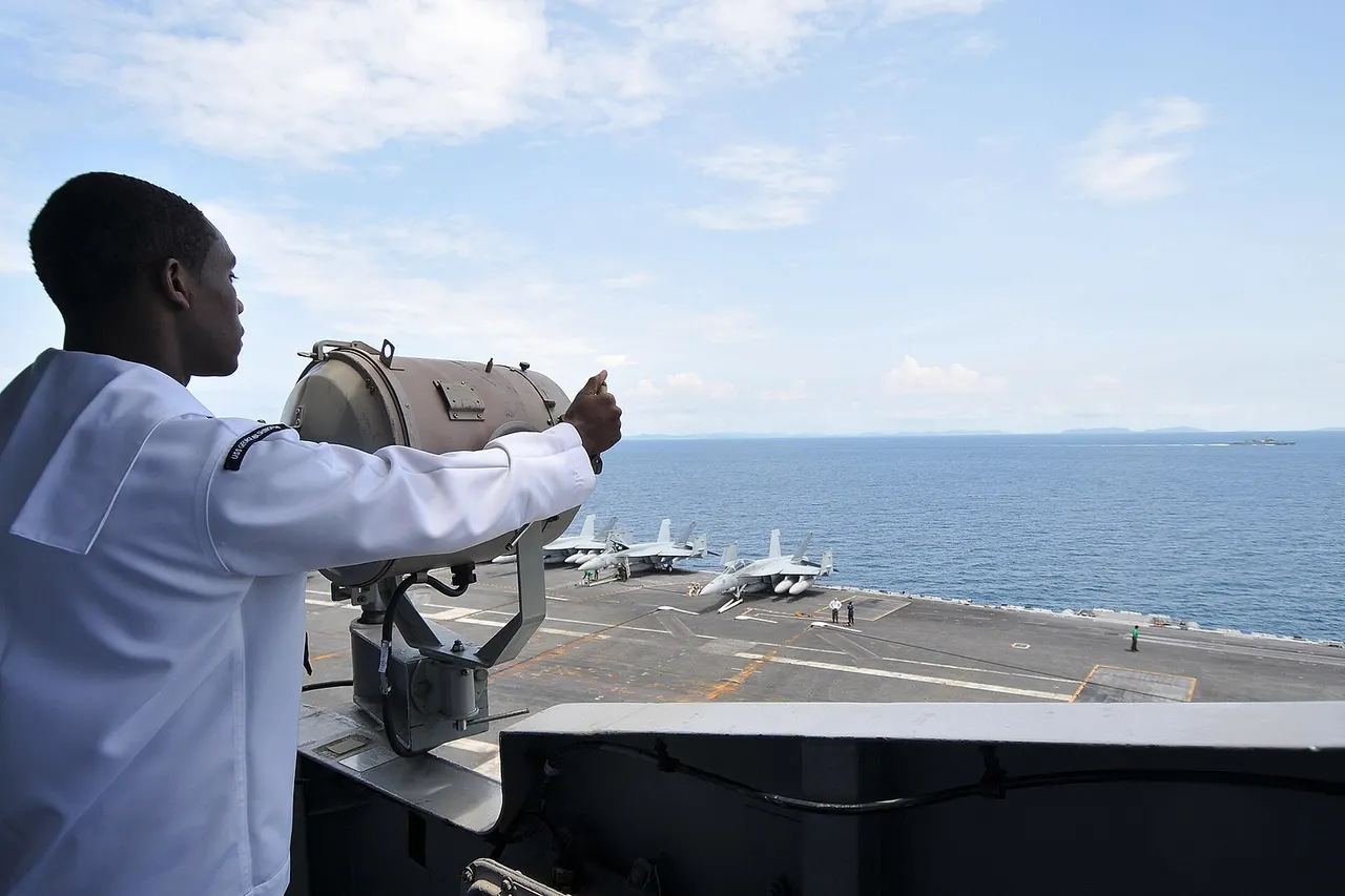 PACFIC OCEAN (Oct. 7, 2010) Quarter Master Seaman Jason Gibson signals to the Royal Thai Navy frigate HTMS Kraburi (FF47) during a Morse code drill between the aircraft carrier USS George Washington (CVN 73) and the Royal Thai Navy. George Washington, the Navy's only permanently forward-deployed aircraft carrier, is underway helping to ensure security and stability in the western Pacific Ocean. (U.S. Navy photo by Mass Communication Specialist 3rd Class Stephanie Smith/Released)