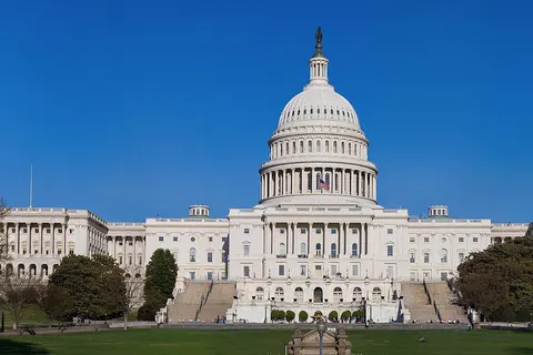 The western front of the United States Capitol . The Capitol serves as the seat of government for the United States Congress , the legislative branch of the U.S. federal government . It is located in Washington, D.C. , on top of Capitol Hill at the east end of the National Mall . The building is marked by its central dome above a rotunda and two wings. It is an exemplar of the Neoclassical architecture style .
