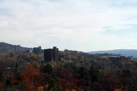 Landscape view of downtown Fayetteville, Arkansas. The photo features the Fayetteville Historic Square (center) and Fayetteville Public Library (right).