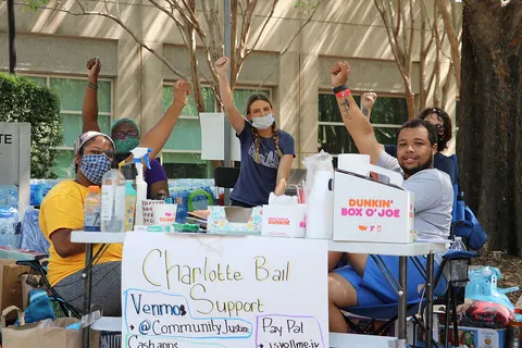 Two protestors at a protest station at the Mecklenburg County Jail during the George Floyd protests.