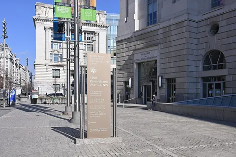 The sign for all the organizations in the Ronald Reagan Building and International Trade Center with the entrance to the US Agency for International Development, commonly called USAID behind it. This is on the West side of the Ronald Reagan Building. 1300 Pennsylvania Avenue NW, Washington, DC 20004.
