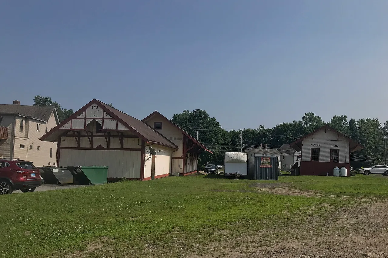 Facing south on the end of the former New Haven Railroad Colchester Branch. The passenger station on the left is now a package store and the freight house on the right is now a bike shop.
