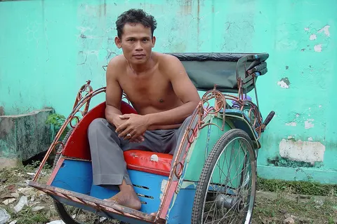 Becak driver, just outside of the city of Jakarta Indonesia .