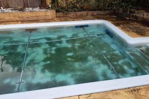 A sequence of images on swimming pool maintenance on a fiberglass pool in Perth, Western Australia. An approximately 45 year old pool shell was recoated and repainted.