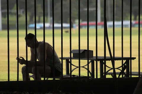 Man using mobile phone, Moore Park, Sydney
