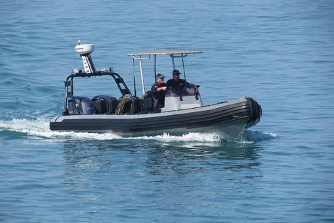 NT Police Rigid Hull Inflatable Boat. The Tactical RHIB is an 8.5 metre Gemini Waverider. On this day it was patrolling around the Stokes Hill Wharf area and among the entrants of the Darwin Ambon yacht race as they waited for the start. Note the new NT Police black uniforms worn in the Top End since July 2012.