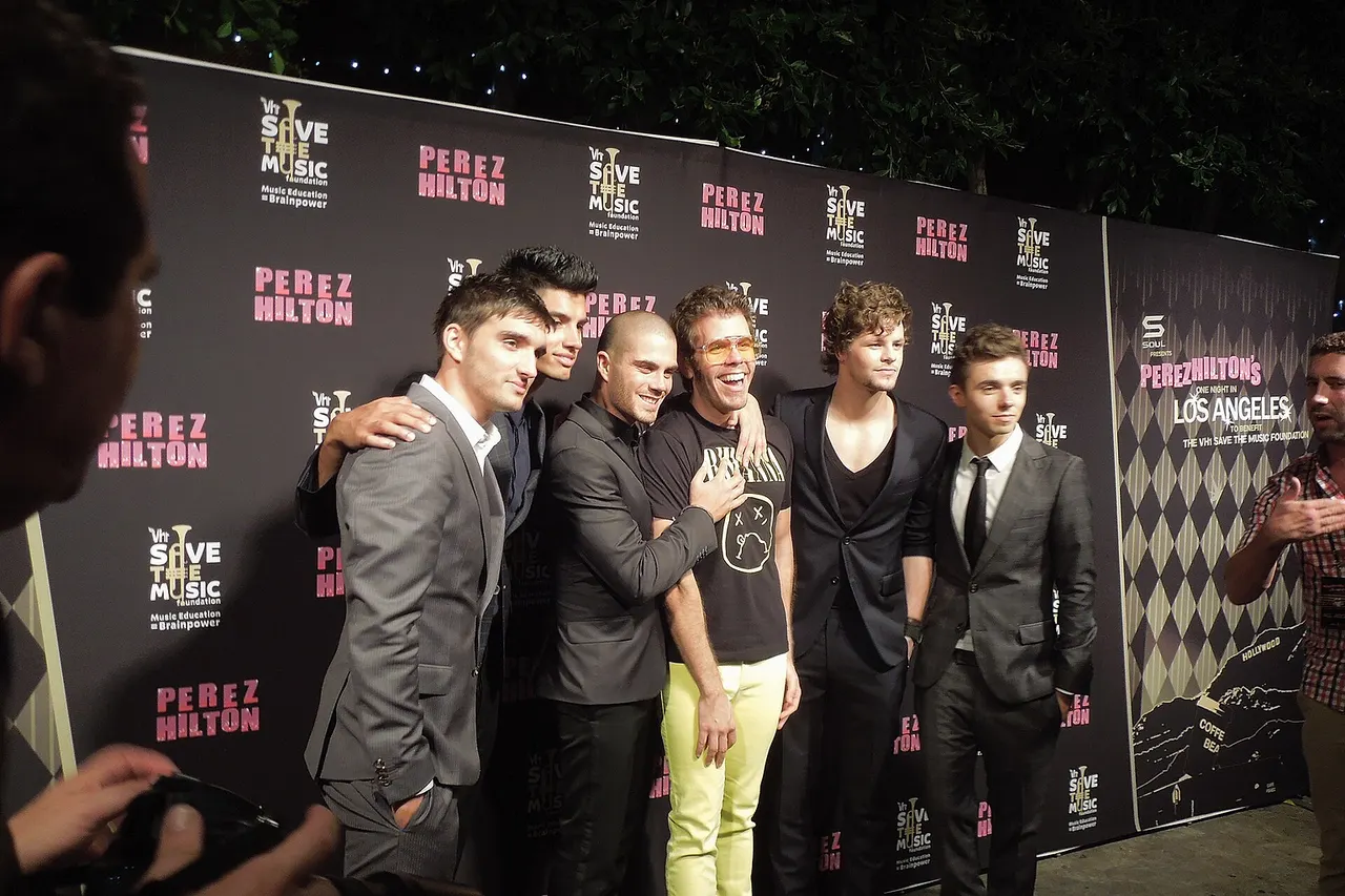 The Wanted poses with Perez Hilton before they take the stage.