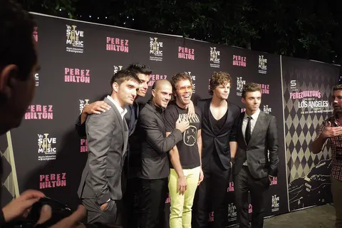 The Wanted poses with Perez Hilton before they take the stage.
