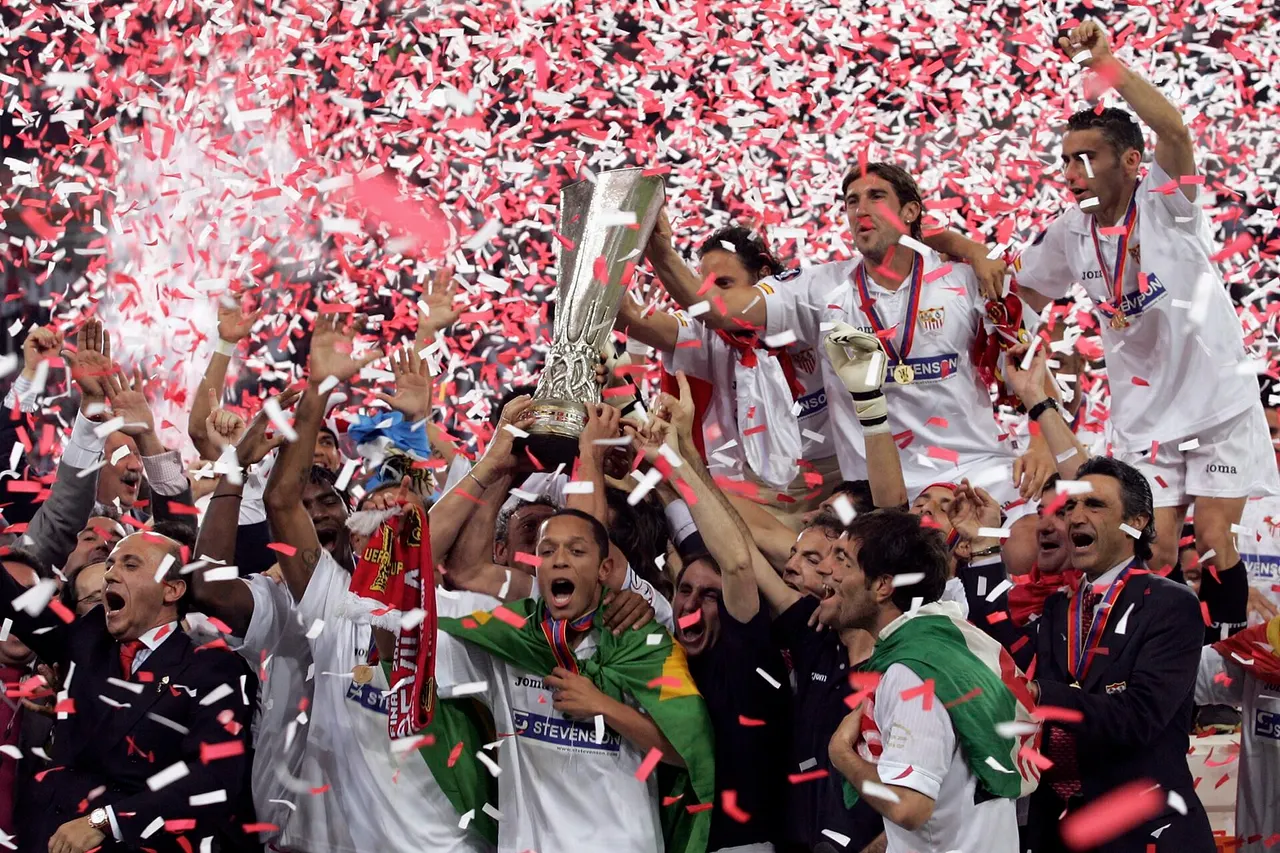 Players of Sevilla FC celebrate with the UEFA Cup trophy after the UEFA Cup soccer final against Middlesbrough FC at the Philips Stadium in Eindhoven, Netherlands, Wednesday 10 May 2006. Sevilla won 4-0.