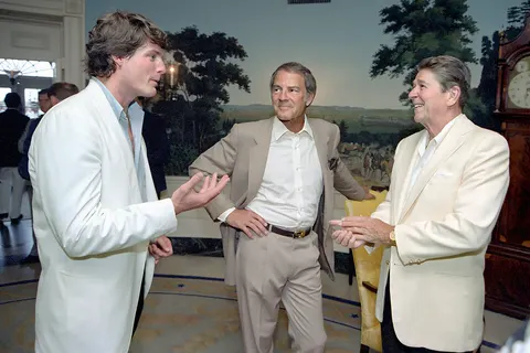 President Reagan talking with Christopher Reeve and Frank Gifford during a reception and picnic in honor of the 15th Anniversary of the Special Olympics program in the Diplomatic Reception room.