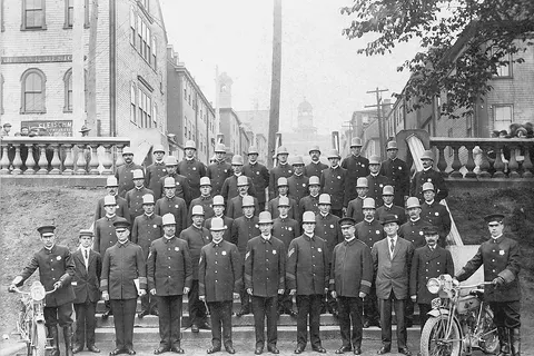 Halifax City Police on the Grand Parade, Halifax, Nova Scotia, Canada, 10 July, 1914. The Halifax Herald for 11 July 1914 reported that: "There was a general inspection of the Halifax police force yesterday afternoon on the Parade . The policemen were out in full force with the exception of one or two who are on the sick list. The inspection was by His Worship Mayor Bligh and Controller Harris. Controllers Hoben and Scanlan were also present. Mayor Bligh add rest [sic] the men in a very flattering manner, congratulating them upon the high standard of efficiency which they have attained and assuring them of the protection and cooperation of the Board of Control. Addresses were then heard from Controllers Harris, Scanlan and Hoben in which they offered suggestions for dealing with some of the problems which the police force has to face and pointing out conditions which make it difficult for the law to be properly enforced. Those who have been attending the lectures were given first aid certificates and a large number qualified. Medals were presented those who had successfully completed the gymnasium course at the YMCA...."