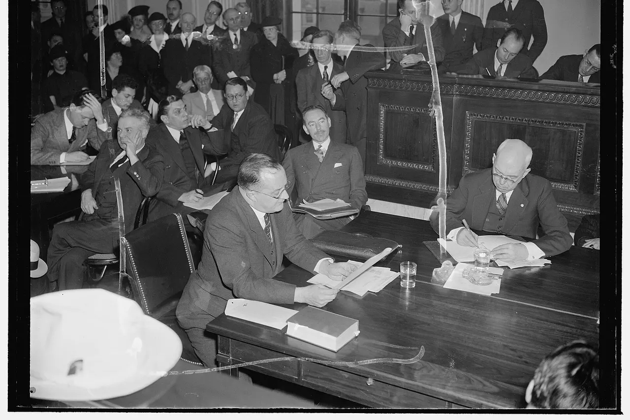 Title: Frankfurter Counsel listens to testimony opposing appointment of Harvard professor. Washington, D.C., Jan. 10. Dean Acheson, right, former Undersecretary of the Treasury, as counsel for Prof. Felix Frankfurter, listens to testimony opposing his client's appointment to the Supreme Court before the Senate Judiciary Subcommittee today. George E. Sullivan, left, Washington Attorney and author, opposed the nomination on the grounds that Frankfurter was alien born--in Austria--and had 'alien affiliations.' 1/10/39 Abstract/medium: 1 negative : glass ; 4 x 5 in. or smaller