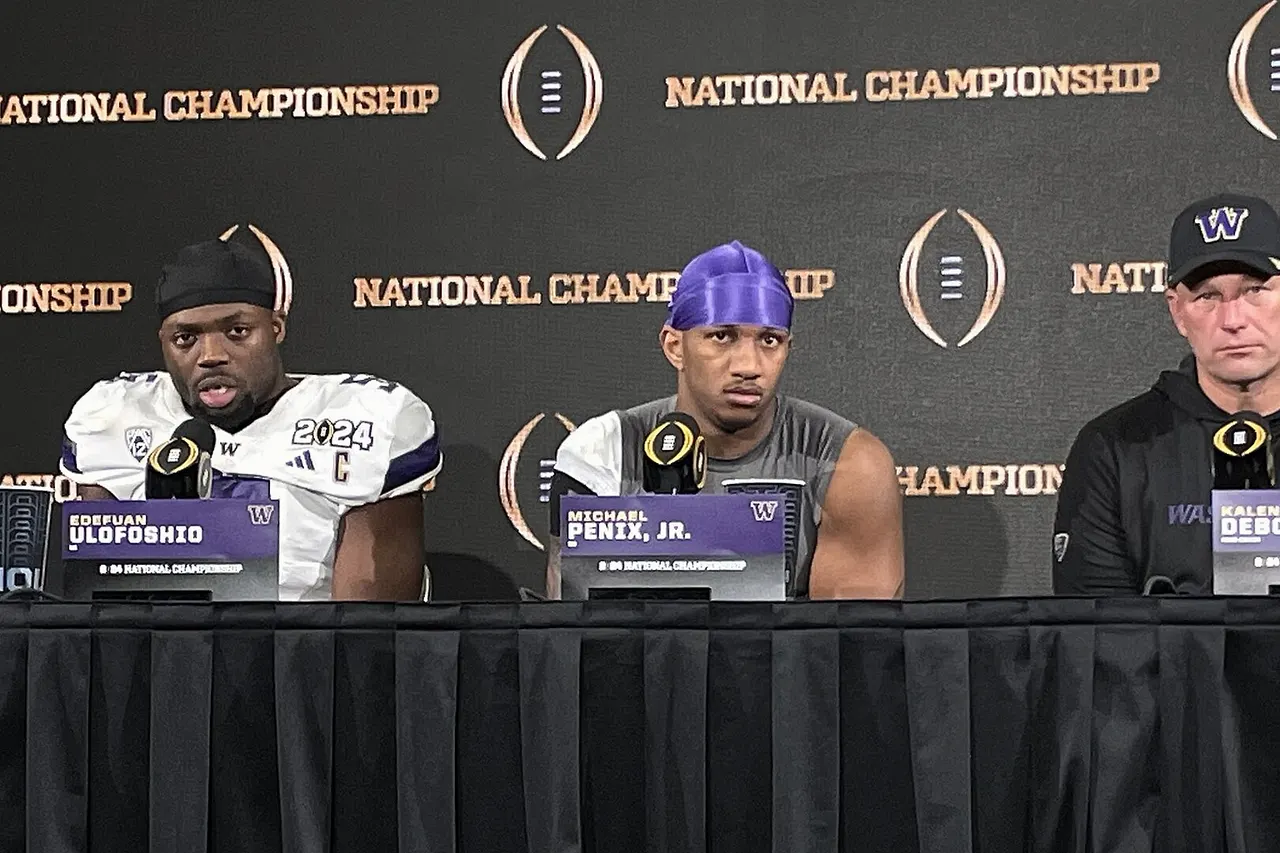 Washington Huskies' Edefuan Ulofoshio ( linebacker ), Michael Penix Jr. ( quarterback ), and Kalen DeBoer (head coach) at the post-game press conference in NRG Stadium after the 2024 College Football Playoff National Championship versus the Michigan Wolverines in Houston .