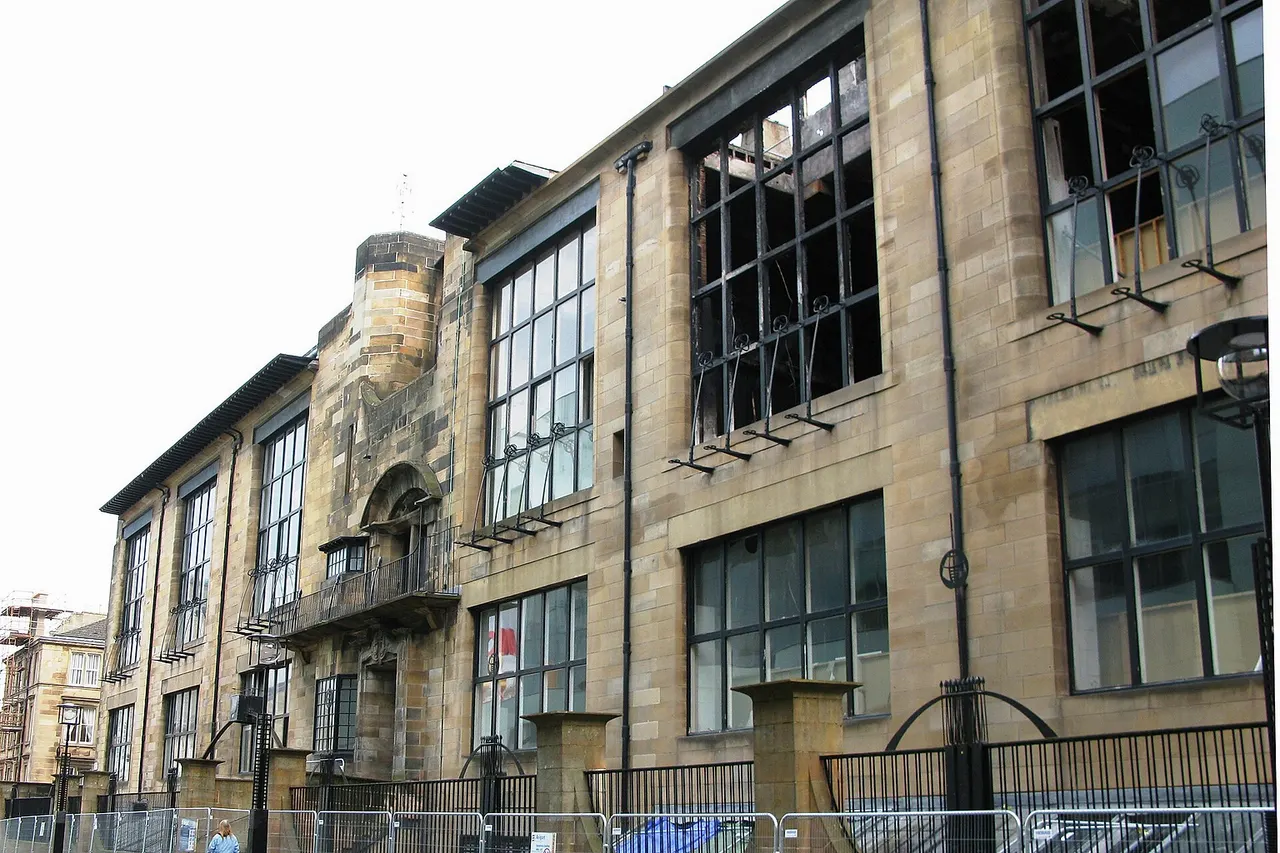 The front (north) facade of Charles Rennie Mackintosh's Glasgow School of Art on Renfrew Street, Garnethill in Glasgow , Scotland . Shown after the fire damage in May 2014.