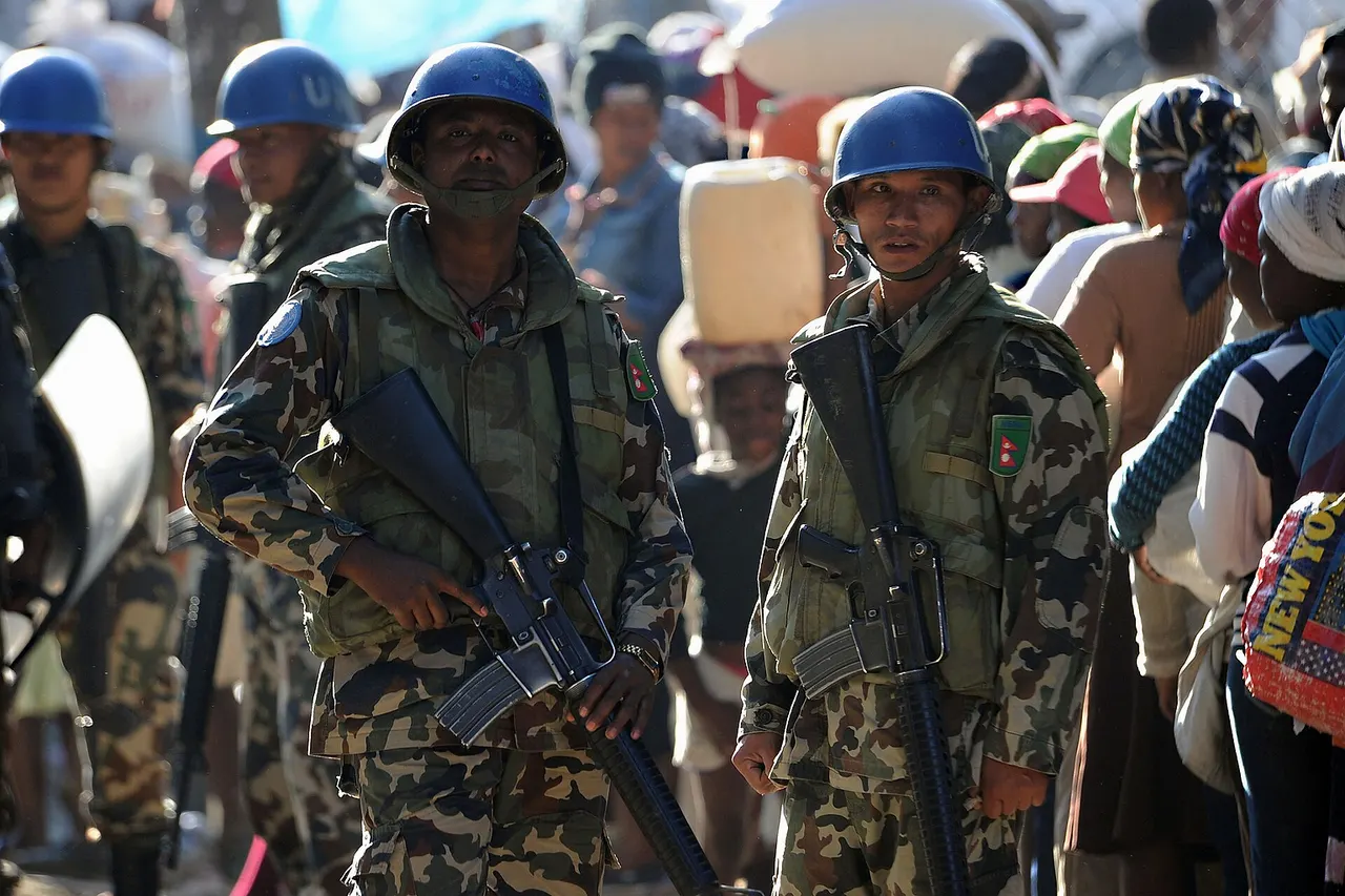 KENSCOFF, Haiti (Feb. 20, 2010) U.N. peacekeepers from Nepal stand by as Haitian citizens wait for rice at a distribution point in Kenscoff, Haiti. (U.S. Navy photo by Senior Chief Mass Communication Specialist Spike Call/Released)