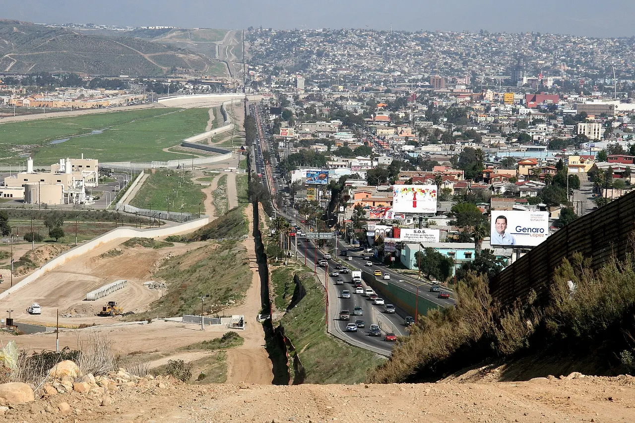 A small fence separates densely-populated Tijuana , Mexico , right, from the United States in the Border Patrol 's San Diego Sector. Construction is underway to extend a secondary fence over the top of this hill and eventually to the Pacific Ocean .