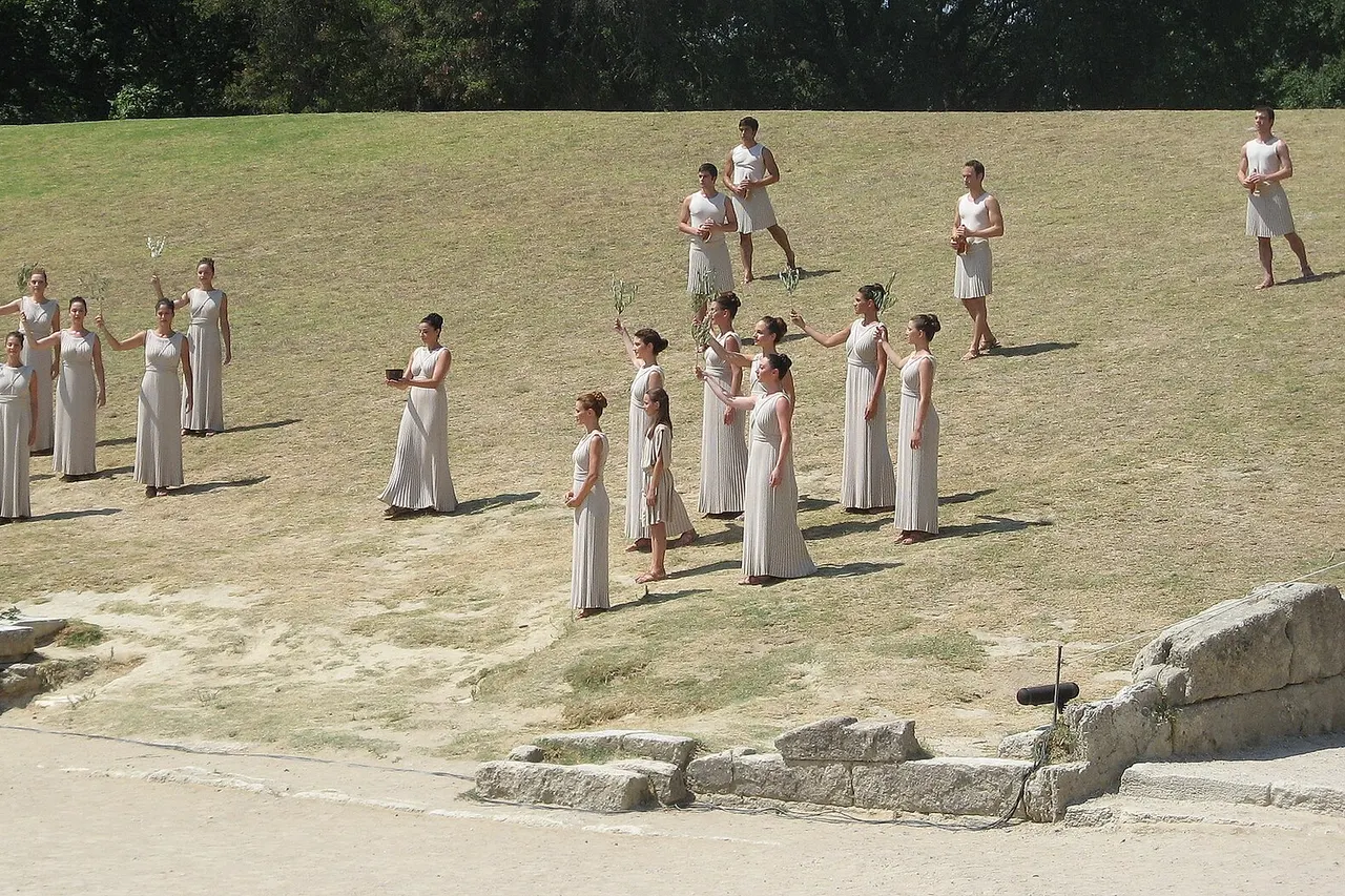 Presentation of the just ignite olympic flame at the olympic torch ignition ceremony for the 2010 Summer Youth Olympics ; Olympia , Greece