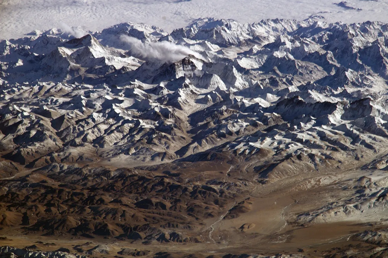Himalaya from the International Space Station . In addition to looking heavenward, NASA helps the world see the Earth in ways no one else can. Astronauts on board the International Space Station recently took advantage of their unique vantage point to photograph the Himalayas , looking south from over the Tibetan Plateau. The perspective is illustrated by the summits of Makalu [left (8,462 metres; 27,765 feet)], Everest [middle (8,848 metres; 29,035 feet)] , Lhotse [middle (8,516 metres; 27,939 feet)] and Cho Oyu [right (8,201 metres; 26,906 feet)] -- at the heights typically flown by commercial aircraft.
